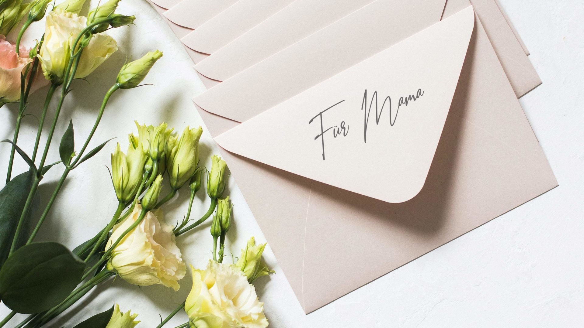 header beispielbild für muttertagsgeschenke mit rosen neben briefumschlägen und der schrift für mama drauf