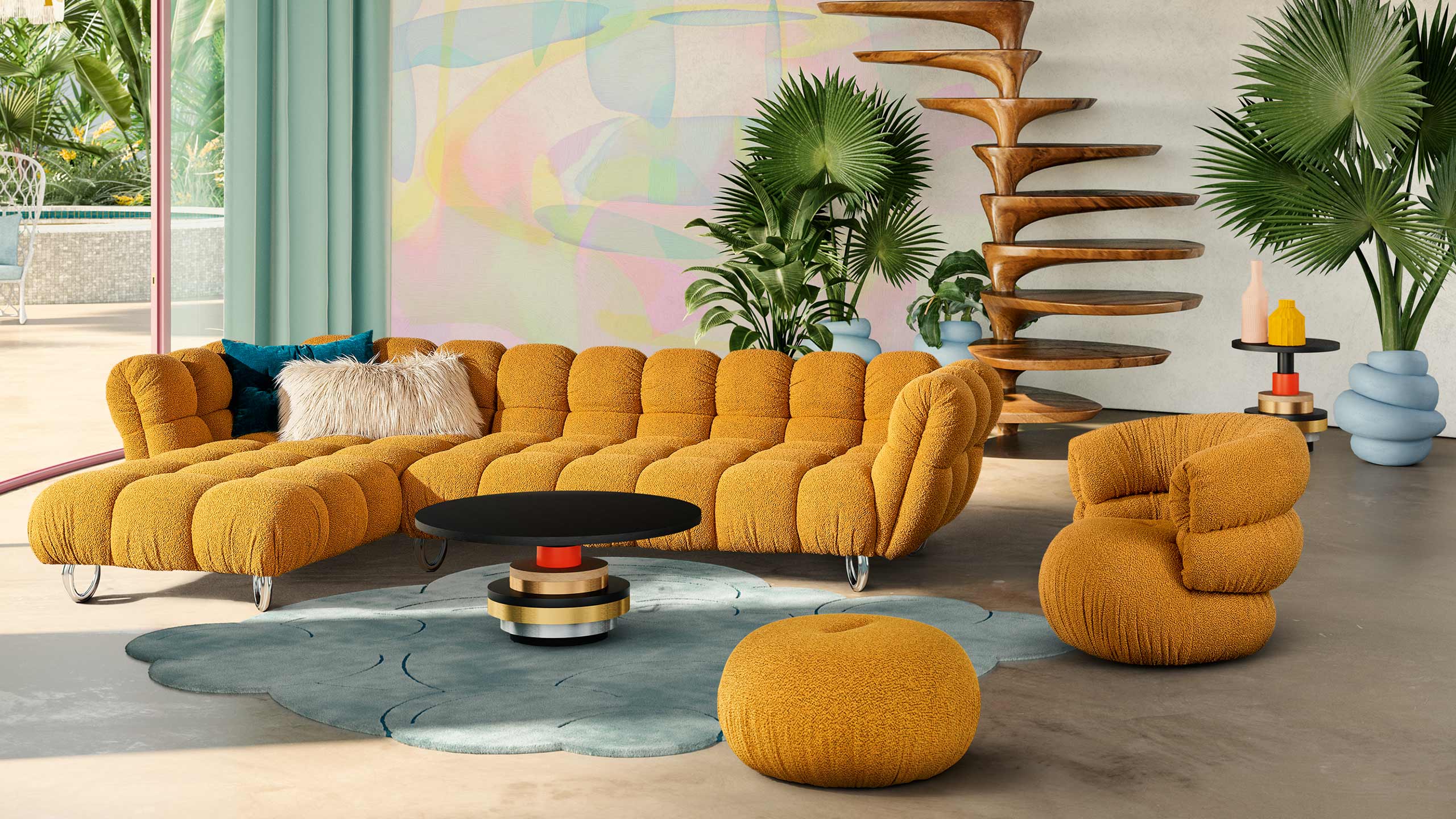bretz balaao sofa und sessel in gelb vor einer bunten wand mit wendeltreppe aus holz