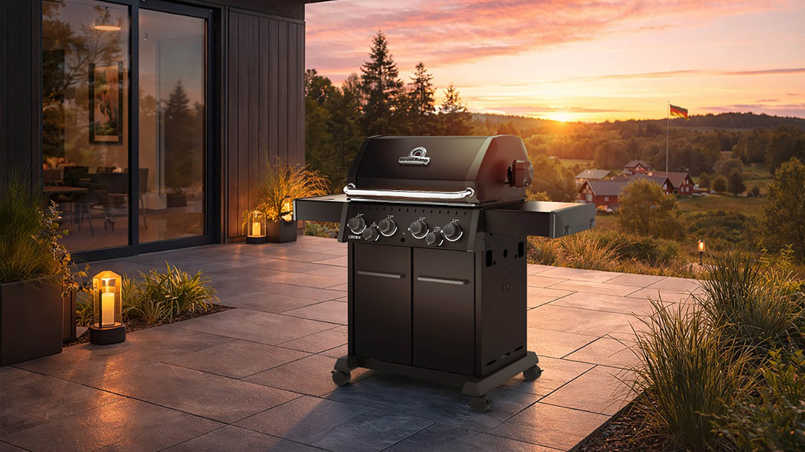 broil king crown 490 gasgrill auf einer terrasse bei sonnenuntergang